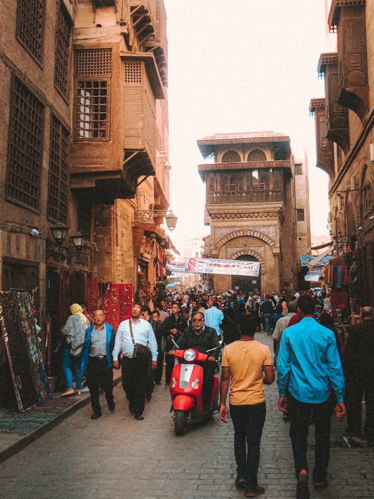 Crowd Of People Walking In Old Narrow Street