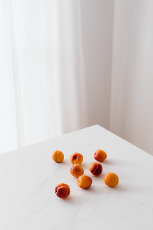 Colorful organic apricots on white table