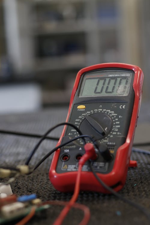 Professional multimeter with wires that combining functions of voltmeter ammeter ohmmeter placed on floor