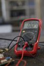 Professional multimeter with wires that combining functions of voltmeter ammeter ohmmeter placed on floor
