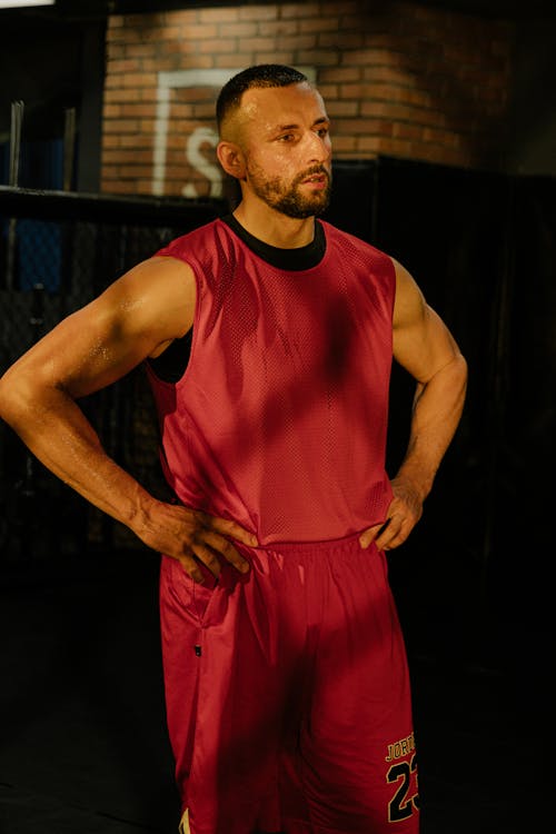 A Man in Red Tank Top and Red Shorts