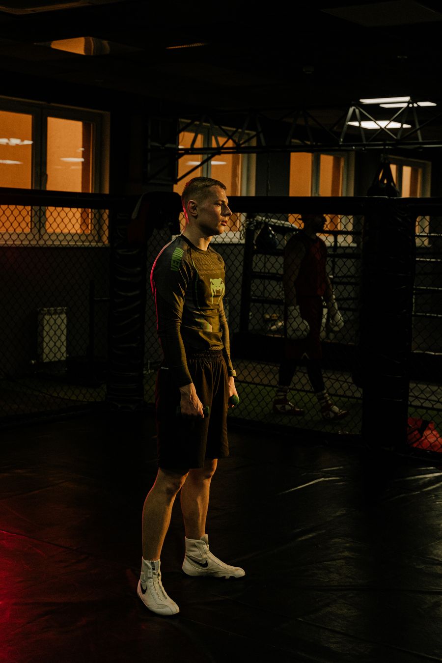 Man training strength and conditioning in dim gym