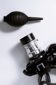 From above of stylish old fashioned photo camera placed with oil for repair