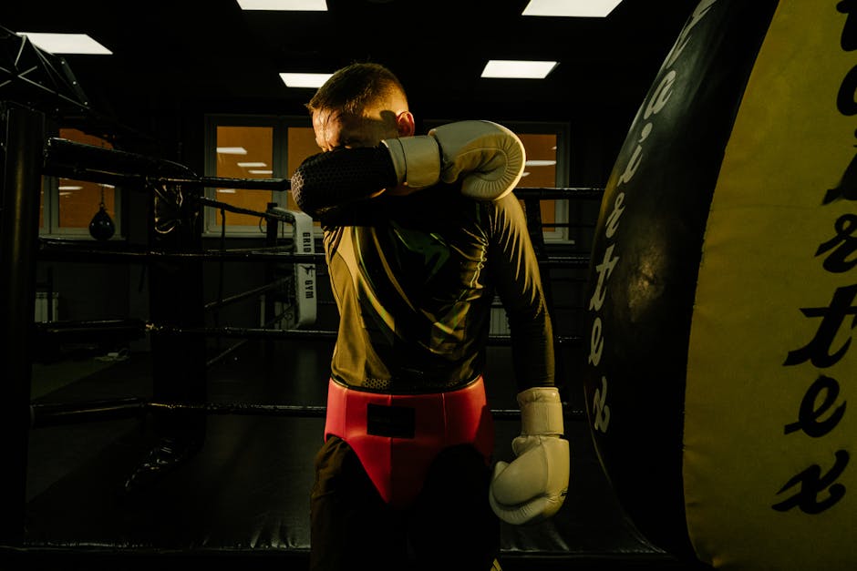 boxer wiping down gloves after training - how to care for leather boxing gloves