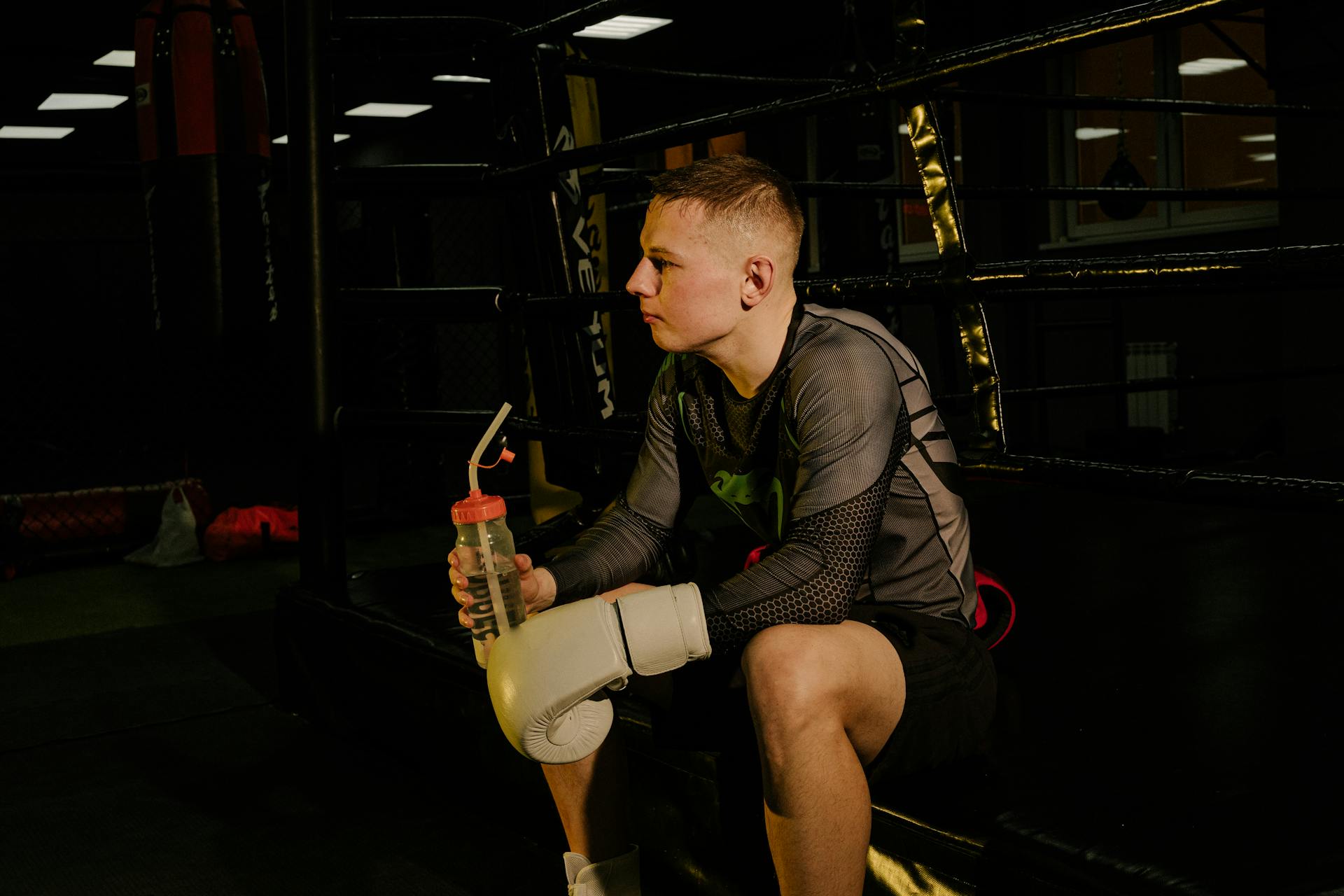 Man Sitting While Holding Water Bottle