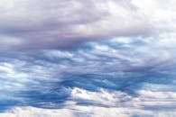 From below of picturesque scenery of cloudy sky with strong wind before thunderstorm during daytime