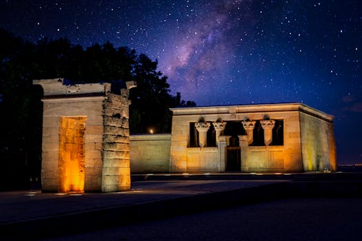 View of the Temple of Debod under a starry sky in Madrid, Spain, illuminated at night.