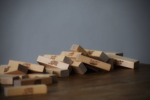 Set of small wooden blocks scattered on table chaotically after playing tower game