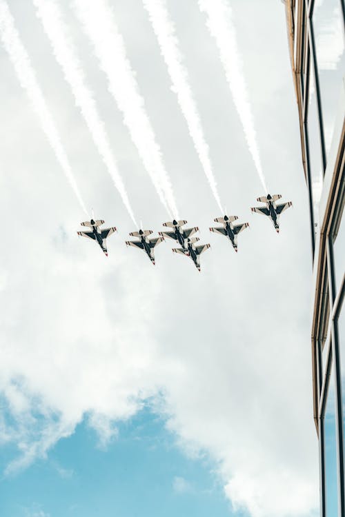 Free Planes flying above modern building Stock Photo