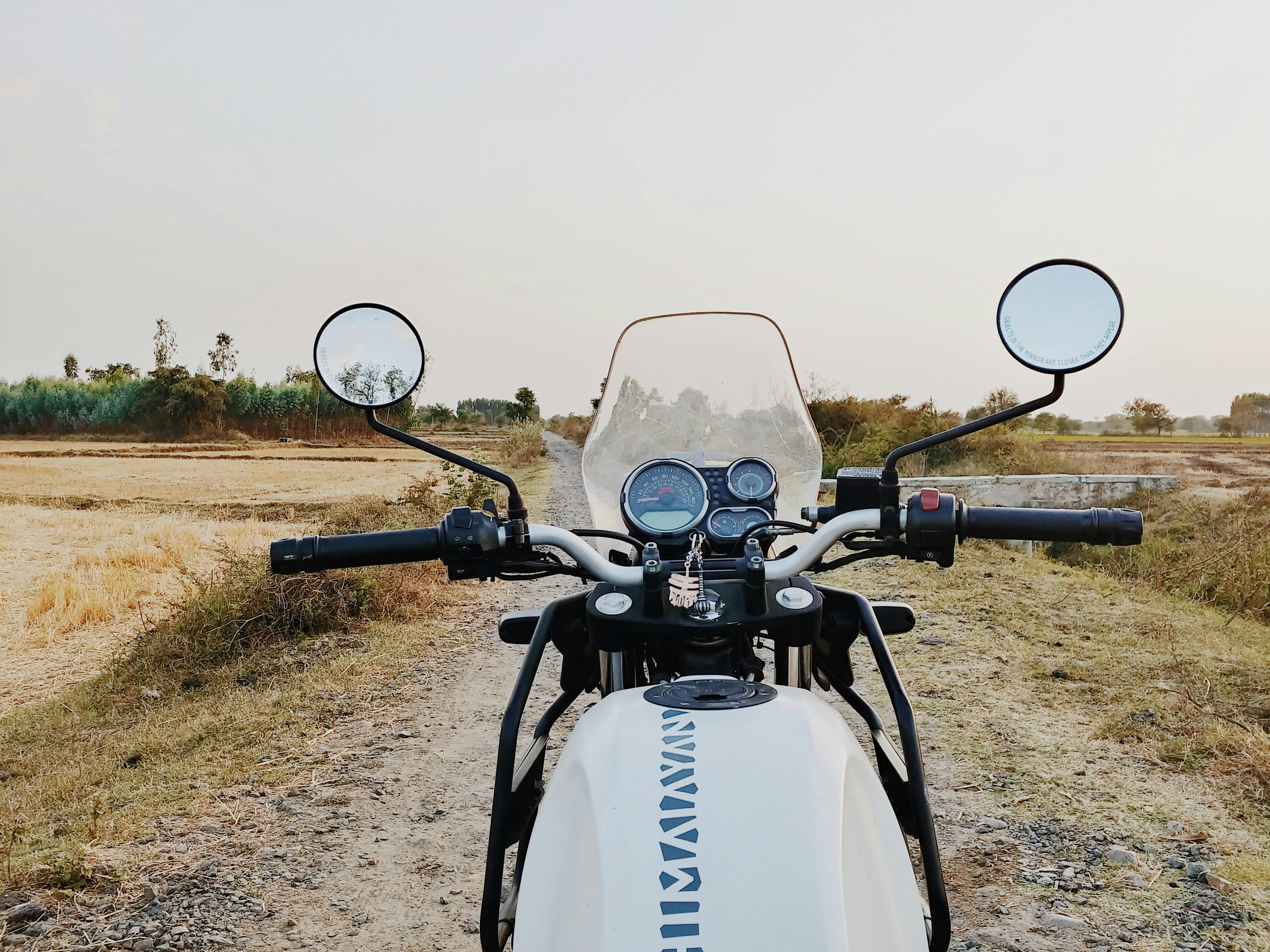 Motorcycle Parked On Walkway Among Field · Free Stock Photo