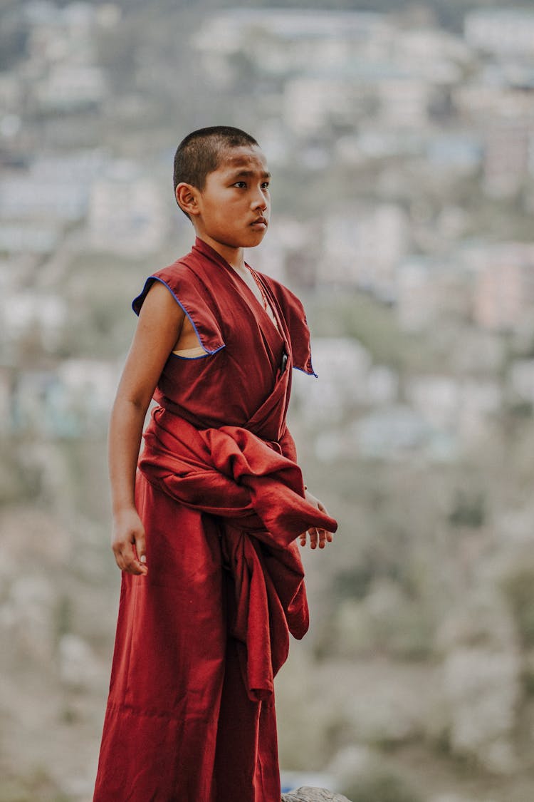 A Boy In Red Monk Robes