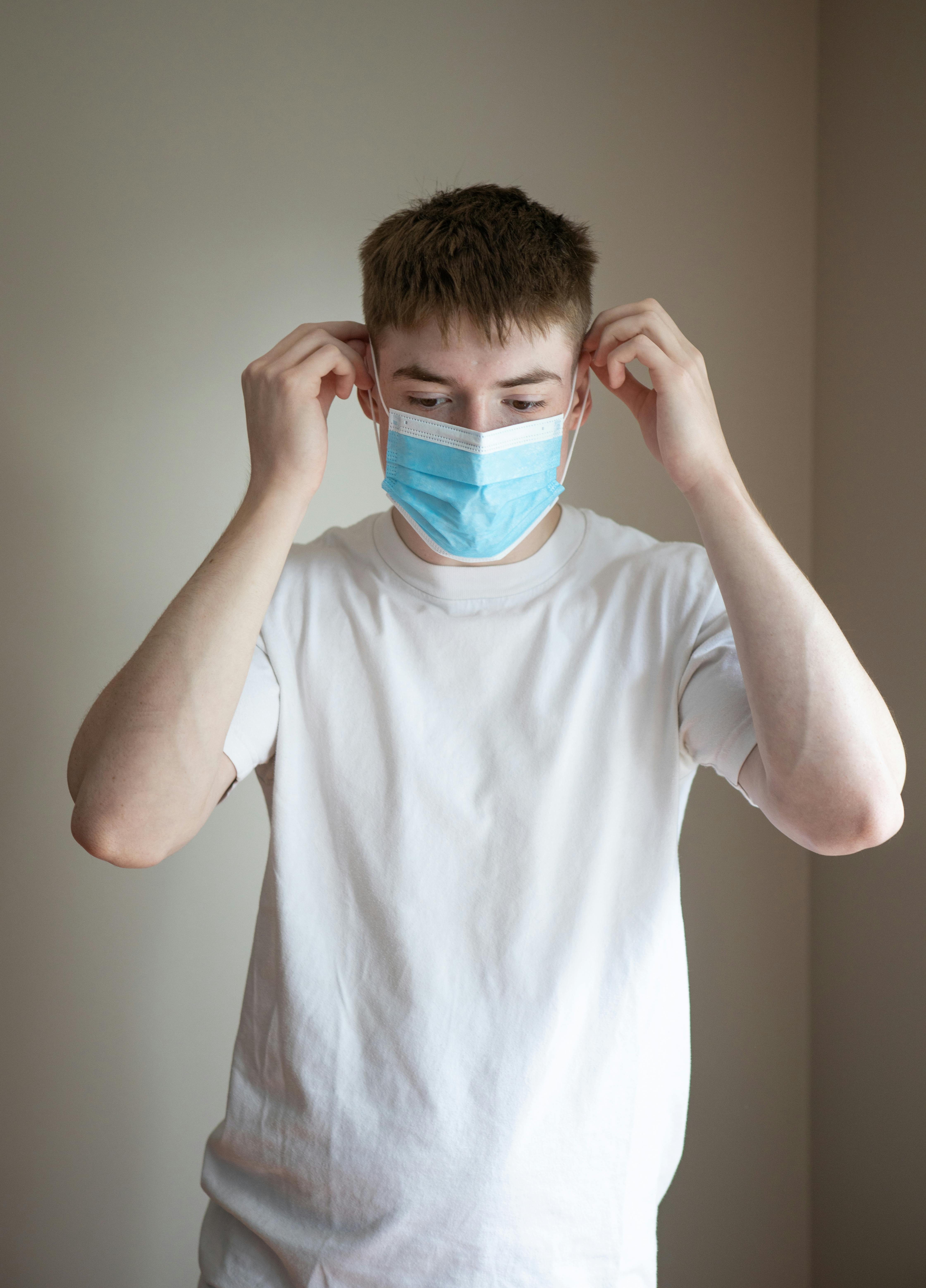 Young Man Courier In Protective Face Mask, Medical Gloves, Santa