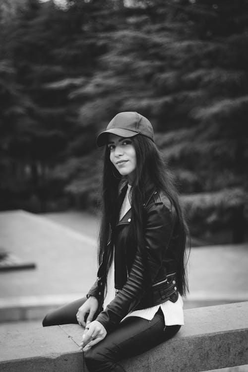 Woman in Black Leather Jacket and Black Pants Wearing Black Hat