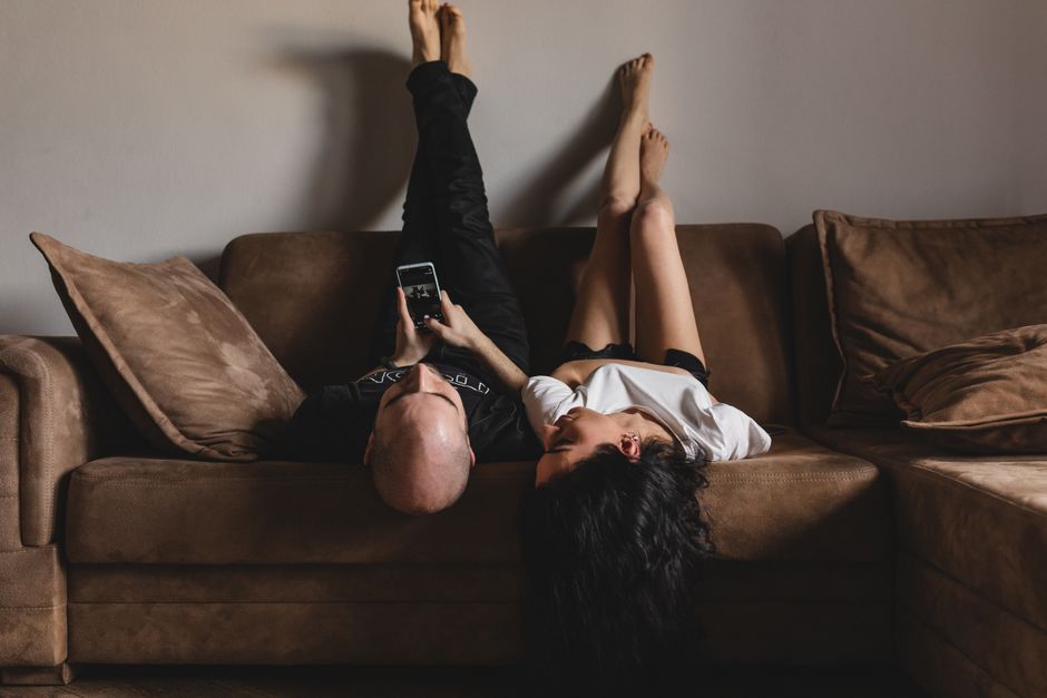 Couple relaxed on a sofa during a virtual therapy session - virtual marriage counseling nationwide Couple relaxed on a sofa during a virtual therapy session - virtual marriage counseling nationwide