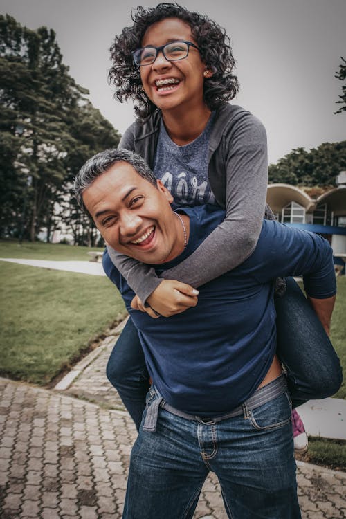 Smiling Man Carrying His Daughter