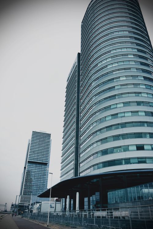 Free Low angle view of modern skyscrapers with glass facades on a cloudy day. Stock Photo
