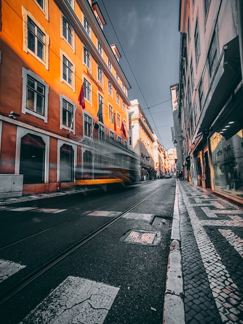 Blurred Motion of Car beside Orange House