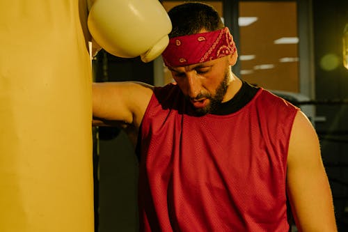 A Man Wearing Red Tank Top and Bandana