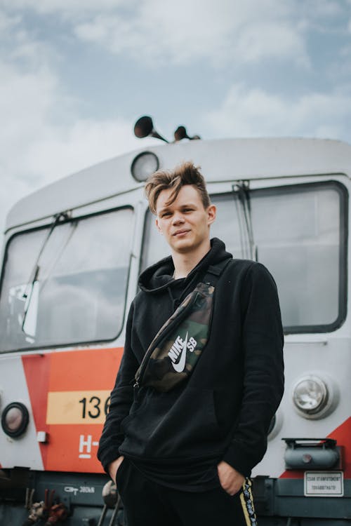 Free A Man Standing in Front of a Train Stock Photo
