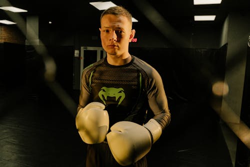 A Man in Active Wear Wearing Boxing Gloves 