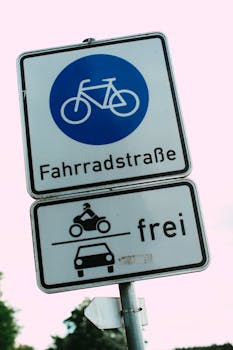 Bicycle road sign with traffic allowance for cars and motorcycles. German traffic symbol.