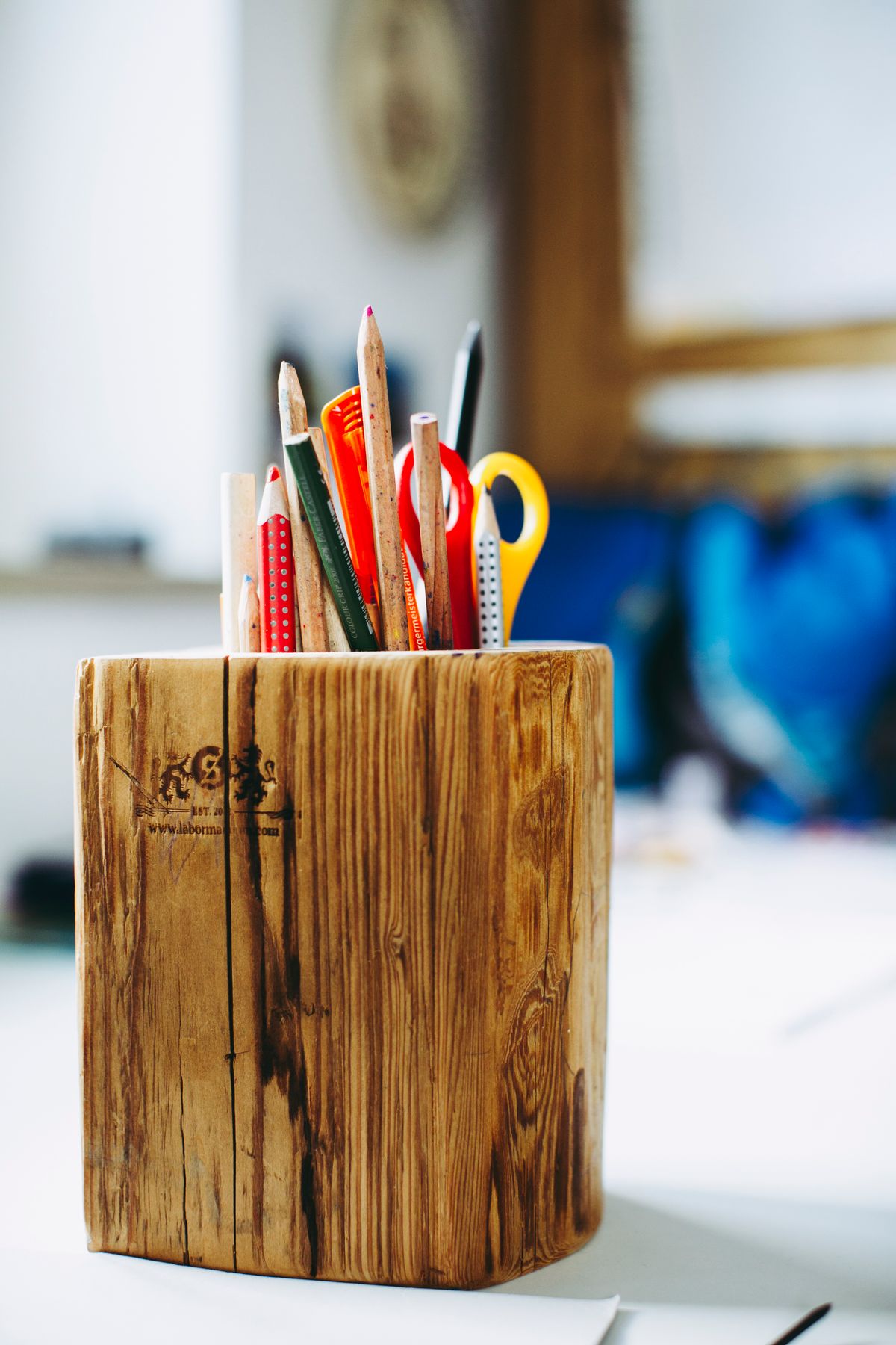 Art and craft supplies arranged in a wooden desk caddy