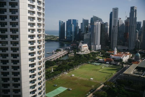 Free Cityscape with contemporary skyscrapers and lawns near sea Stock Photo