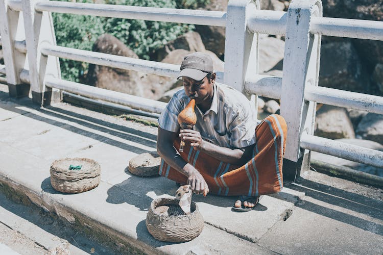 A Man Snake Charming In The Street