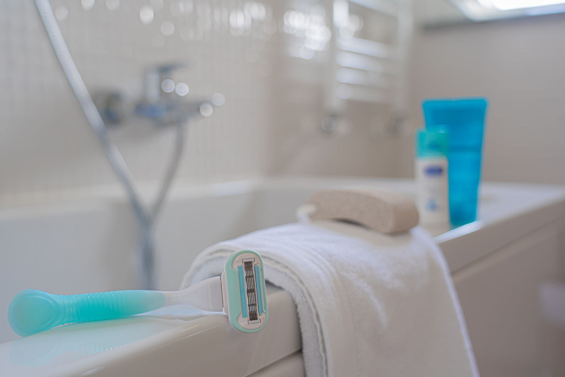 Razor and towel arranged in a clean bathroom personal grooming setting