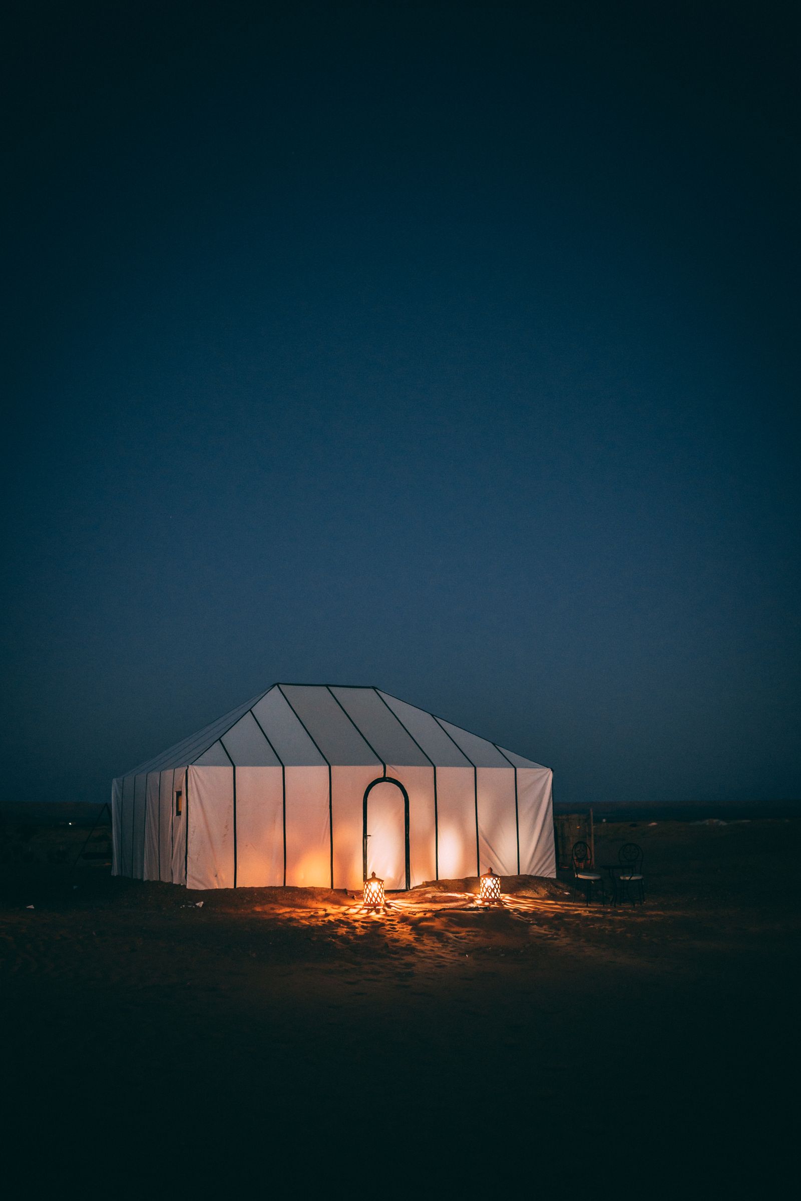 Illuminated desert camp tent at night