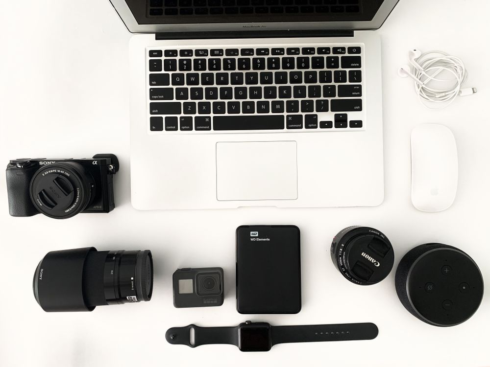 Laptop with photo camera accessories on white background · Free Stock Photo