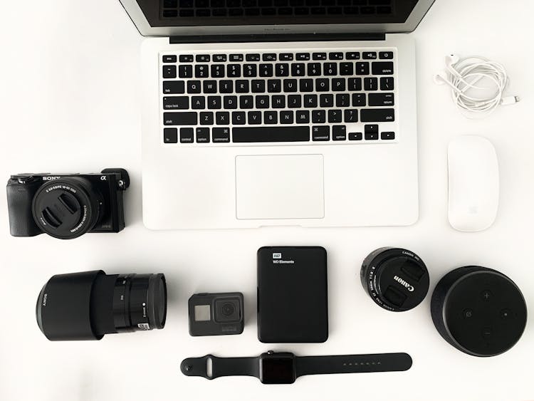 Laptop With Photo Camera Accessories On White Background