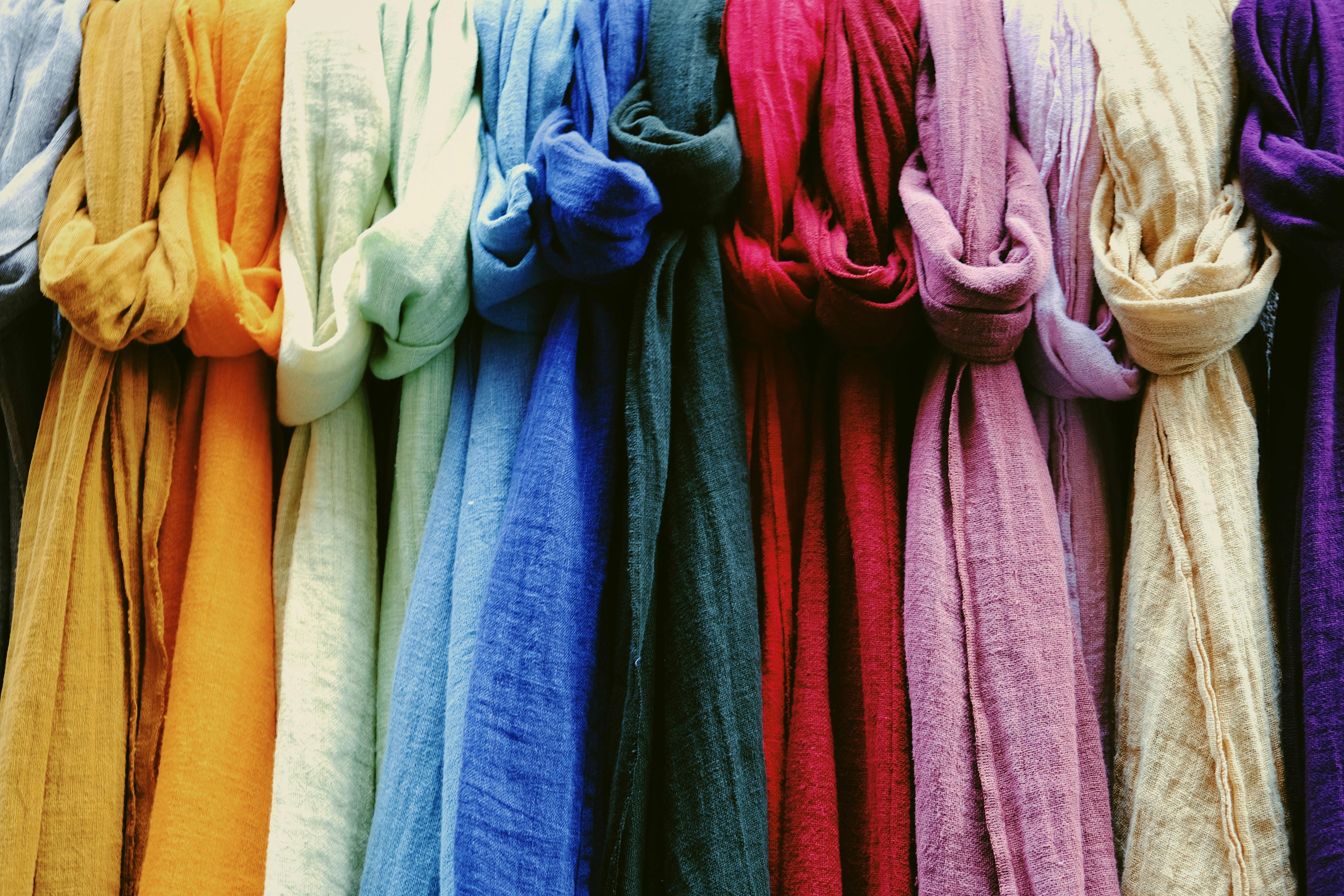 Multicolored linen fabrics for sale in shop · Free Stock Photo