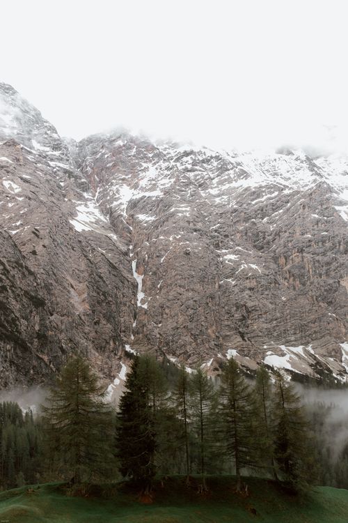 Free High angle of mountain ridge located in mountainous area with green fir trees against cloudy sky Stock Photo