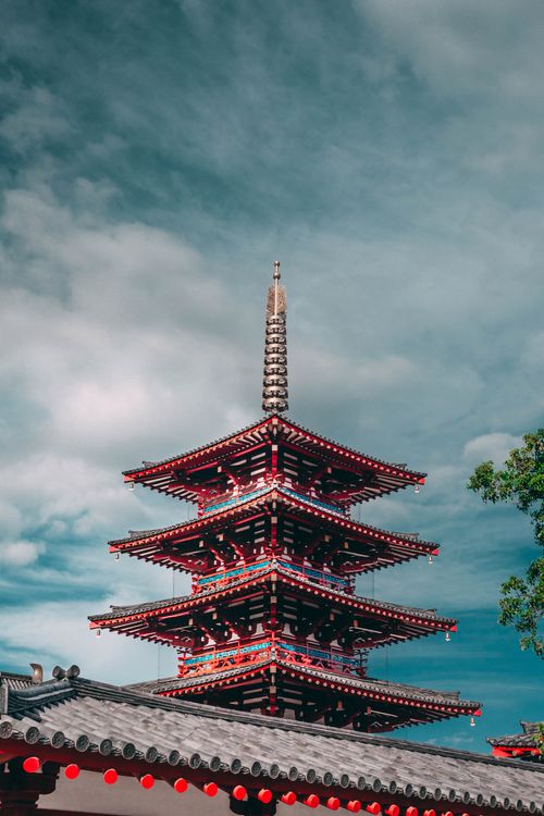 Free Vibrant photo of Shitennoji Temple's pagoda in Osaka, Japan under a bright blue sky. Stock Photo