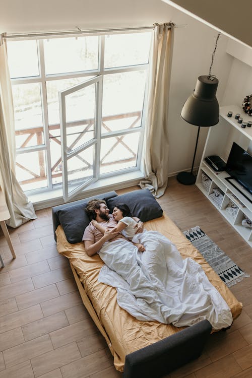 Man and Woman Lying on Bed