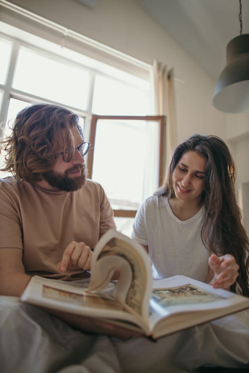 Free Man and Woman Looking At The Book Stock Photo