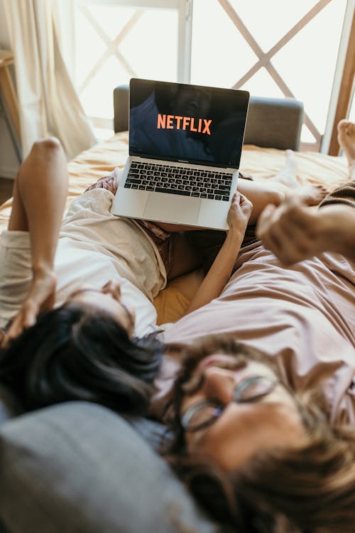 Free A Couple Lying on Bed Watching Netflix on Laptop
 Stock Photo