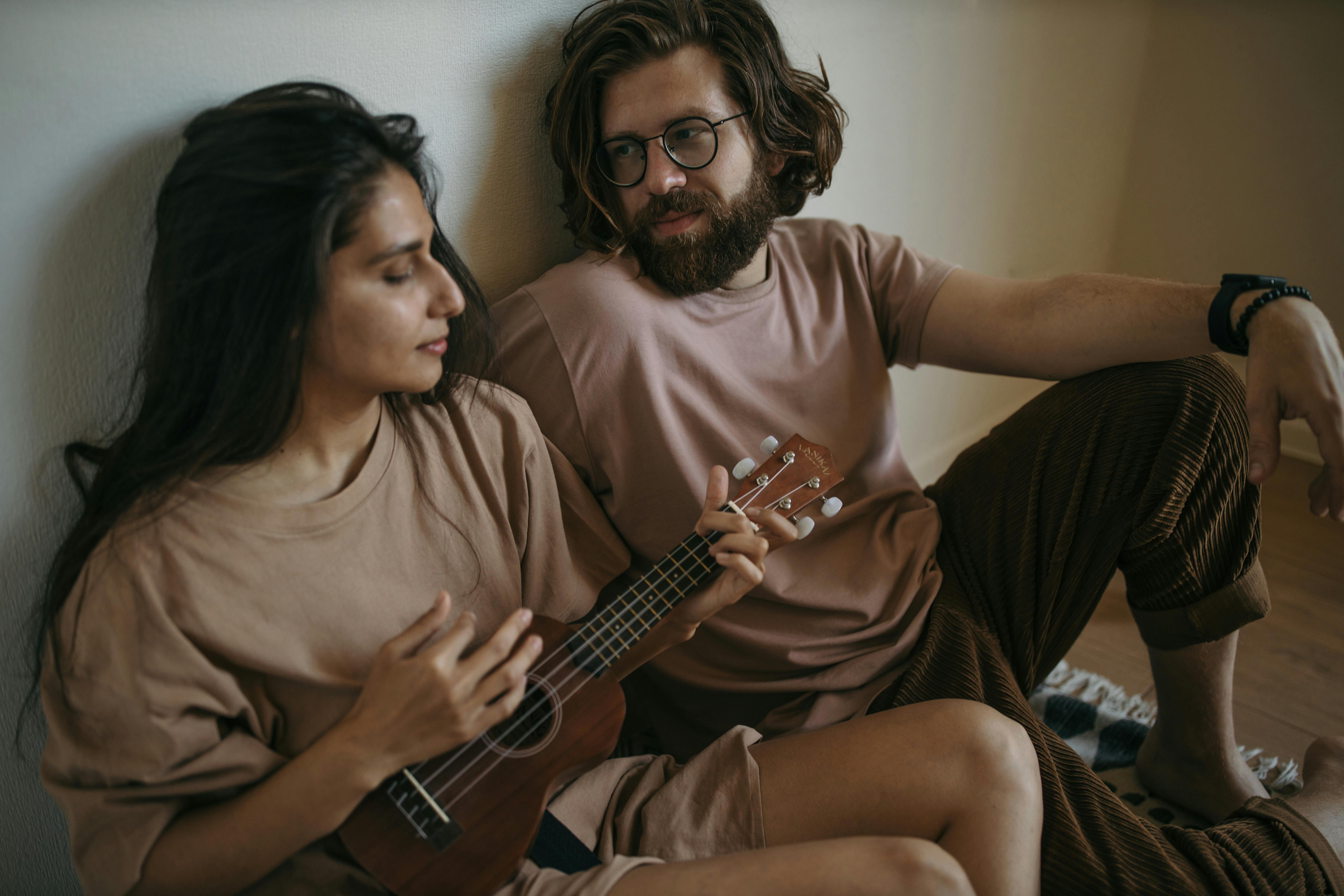 Man and Woman Sitting on Couch