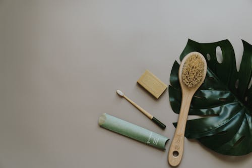  Wooden Brushes Beside bar Soap on Grays Surface