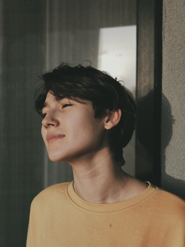 Pensive Young Teen Resting On Terrace On Sunny Day