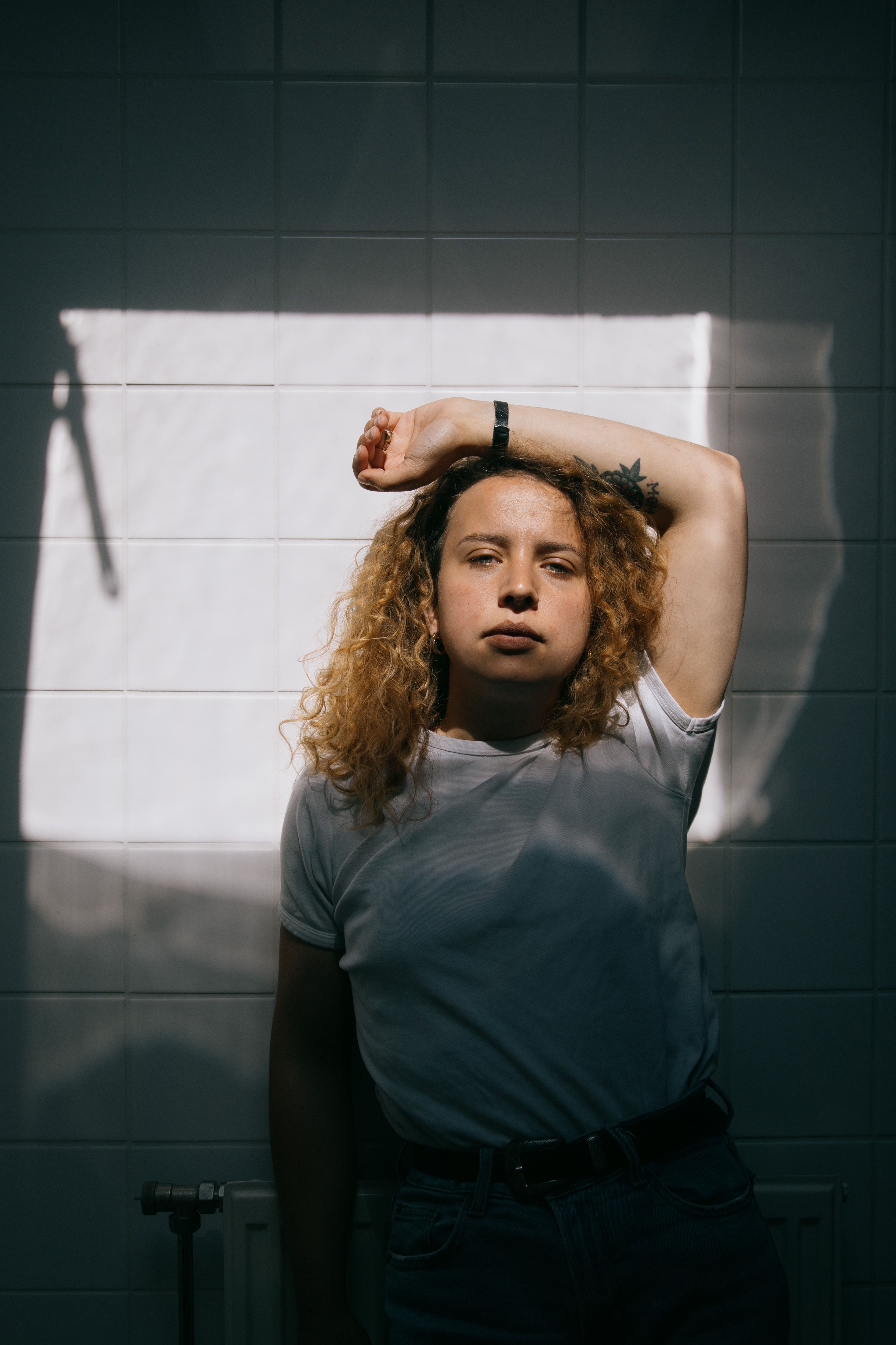 Young woman with red hair standing against wall · Free Stock Photo