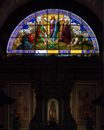 Old arched ceiling of cathedral decorated with colorful icon image on stained glass