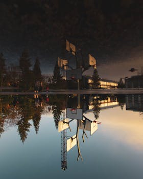 Scenic view of basketball hoops reflecting on water at sunset in Nantes, France.