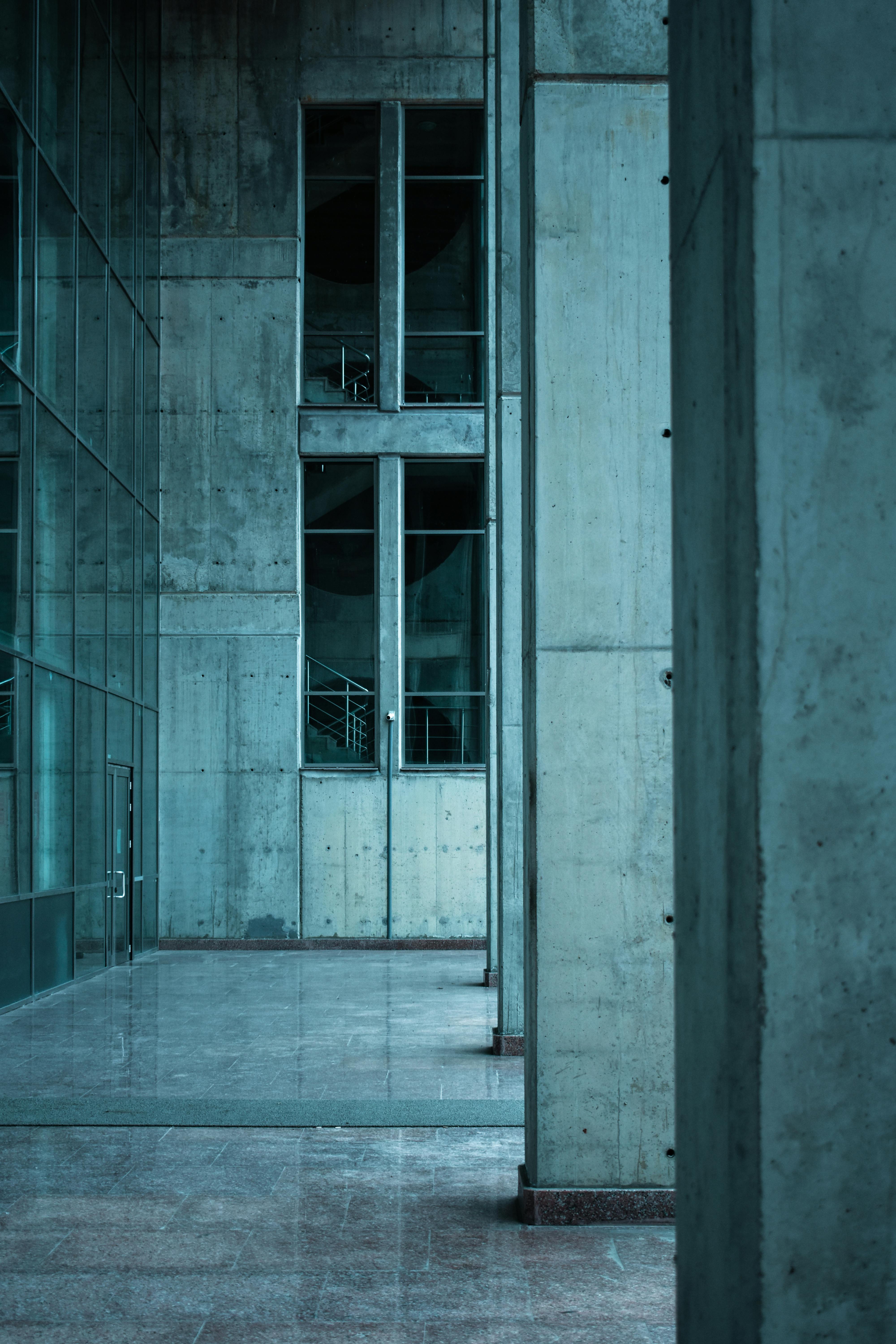 Explore the minimalist design and architectural beauty of this modern corridor with concrete walls and large windows.