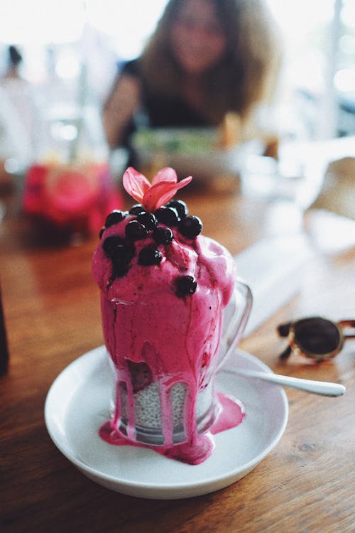 A Delicious Chia Pudding Topped with Oozing Pink Syrup and Berries 