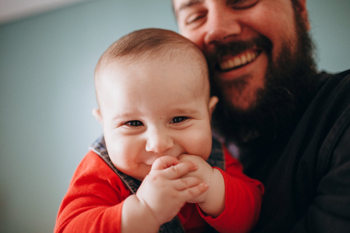 Free bearded Man Carrying his Son Stock Photo