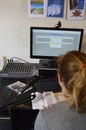 Unrecognizable sound engineer installing software on desktop computer at home