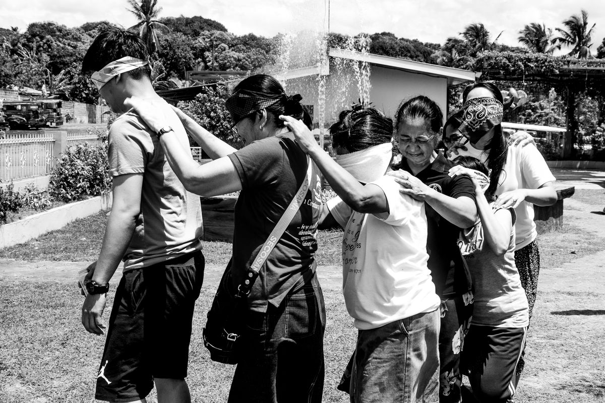 Adults working together in a blindfold coordination exercise