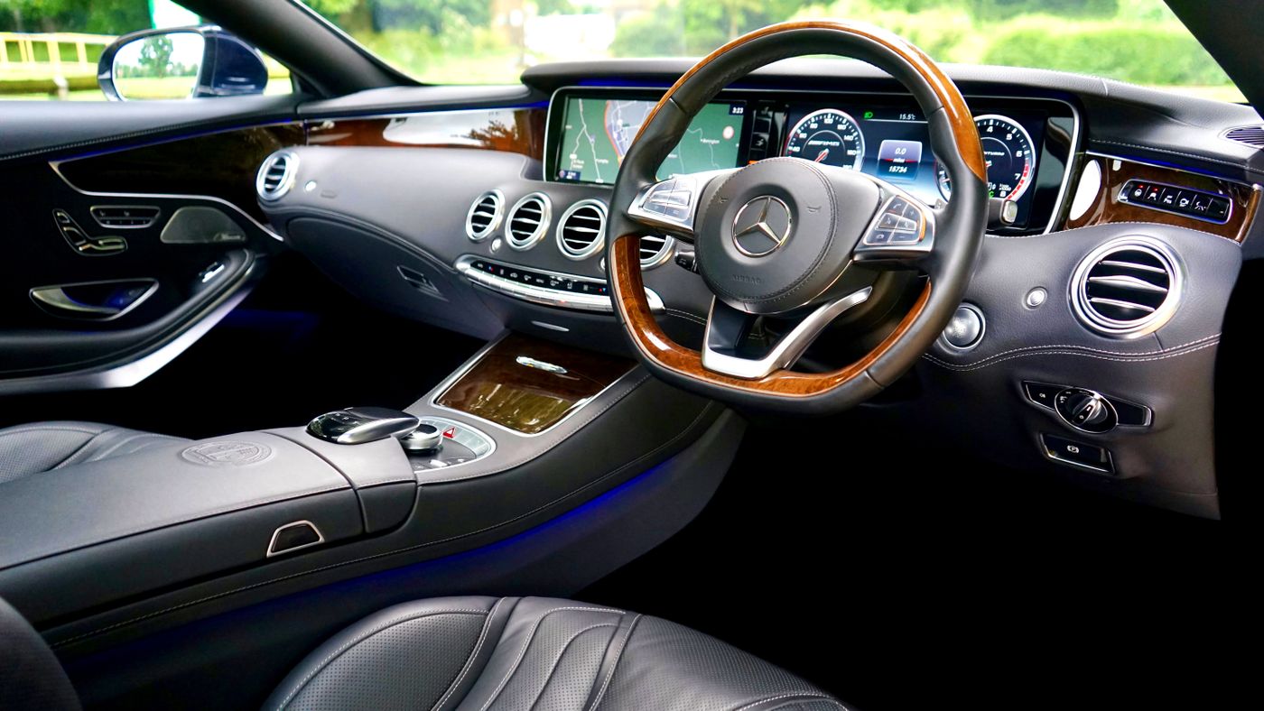 Premium modern car interior with leather seating, dashboard controls, and steering wheel